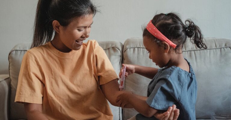 A joyful mother and her daughter playing doctor with a toy syringe in a cozy living room.